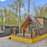 Cabin and RV campsite at Canyon Country Campground in Wellsboro PA surrounded by trees